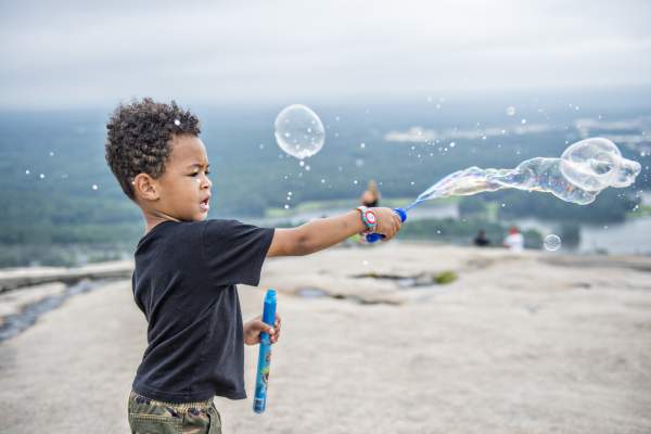 Kid playing with bubbles