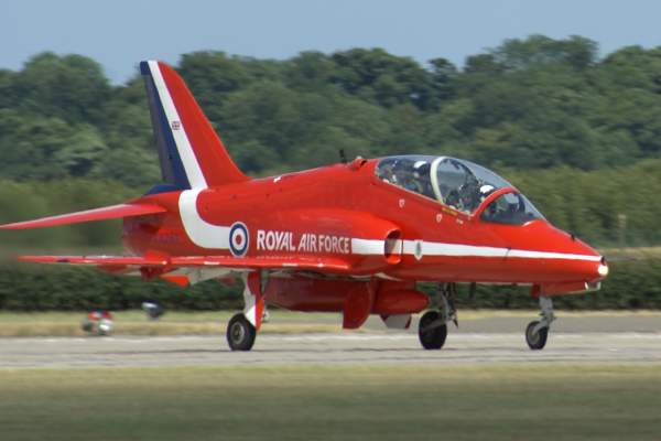 Red arrow plane on the run way getting ready for flight