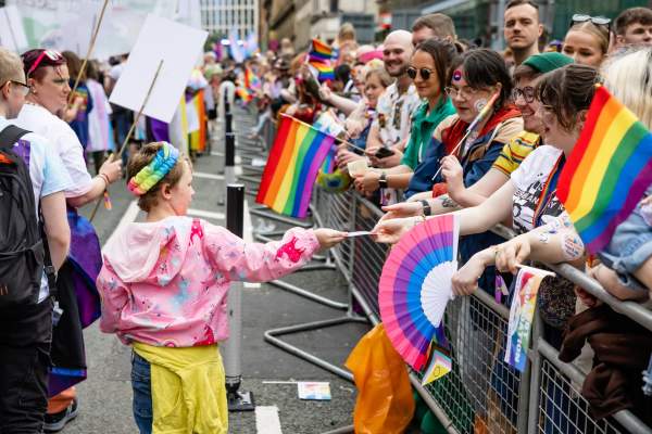 People walking on a pride parade route