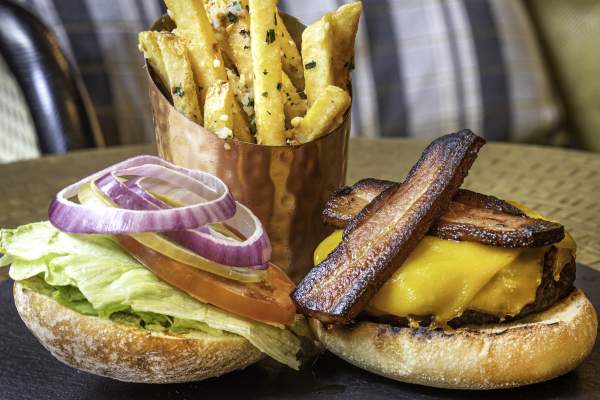 Plate with a bacon cheeseburger and fries