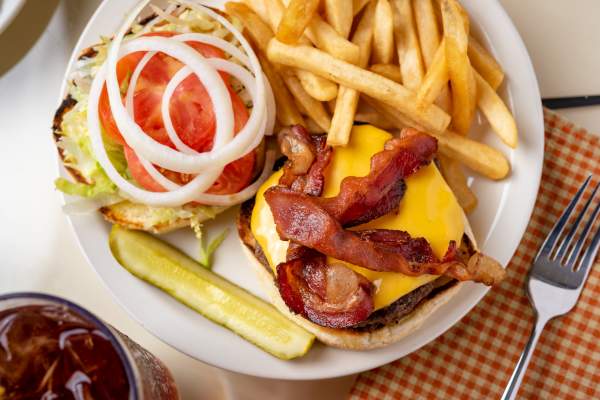 Overhead picture of a plate with an open cheeseburger