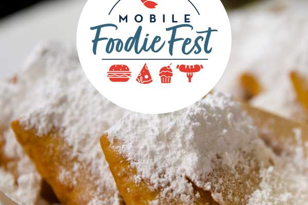 Mobile Foodie Fest with a plate of beignets covered in powered sugar