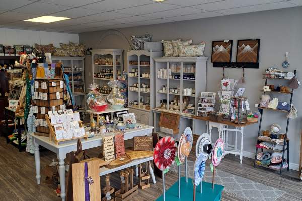 Photograph of inside the shop "At the 100th Mile". Shows open shop space with displays of local artisan made goods
