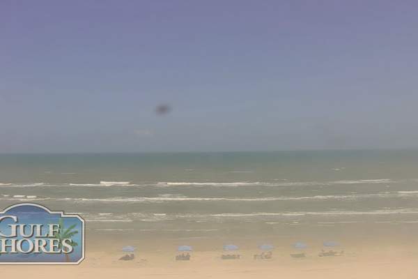 A still image from a webcam showing the beach and chair setups