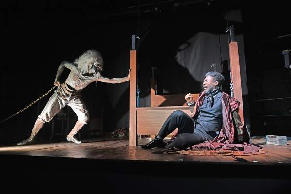 The ghost of Marley frightening Scrooge on stage