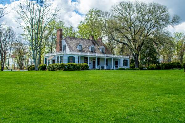 A white house with trees in the background
