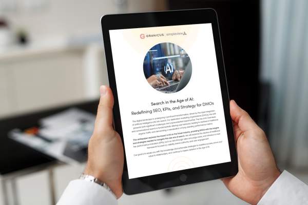 The "Search in the Age of AI: Redefining SEO, KPIs and Strategy for DMOs," whitepaper open to the front cover on an iPad.