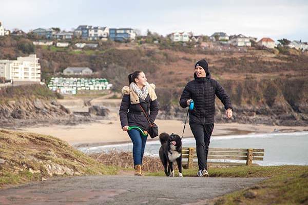 Couple walking their dog in winter clothes