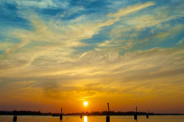 Bright Blue and Orange Sunset at Onondaga Lake Park Shining Down on Water
