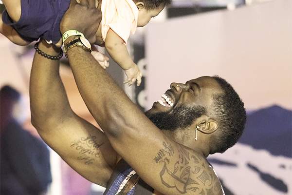 A dad lifts child at Taste of Syracuse