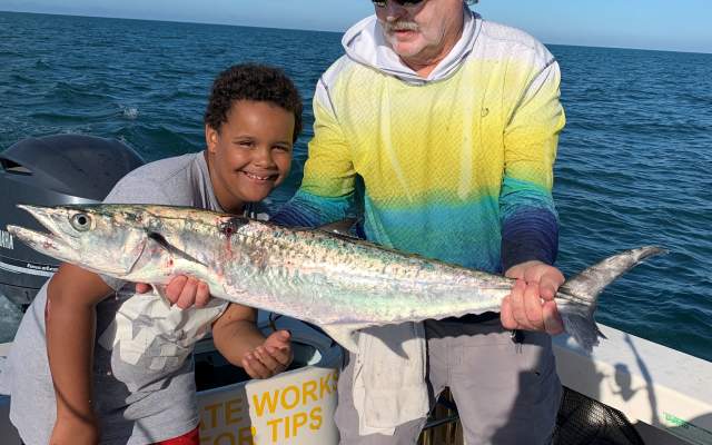 Capt. Van Hubbard and young fisherman holding a freshly-caught King Mackerel