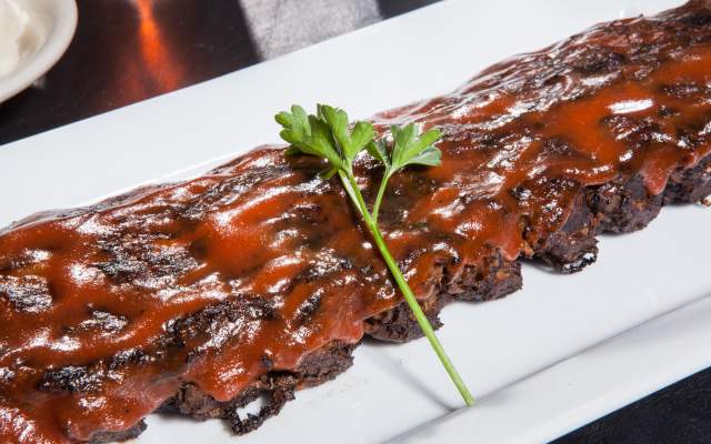 a rack of pork ribs covered in bbq sauce