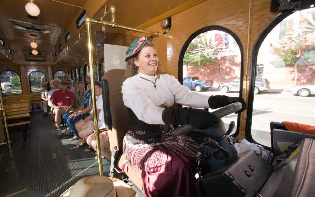 Trolley driver in old west period costume drives passengers around Cheyenne, Wy.