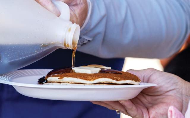 Maple flavored syrup is poured on pancakes at CFD