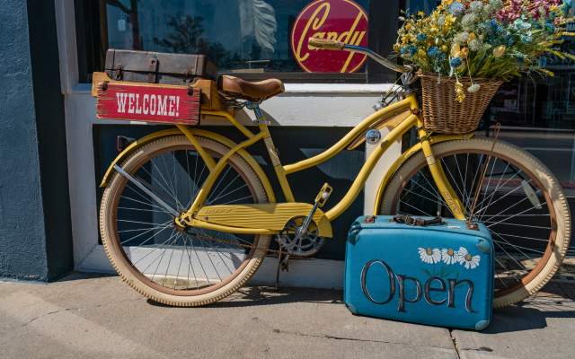 an antique bike rests against the front of a downtown Cheyenne store