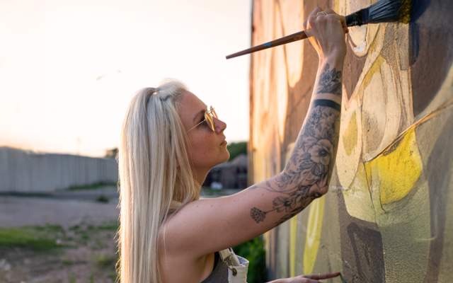 Woman painting a mural