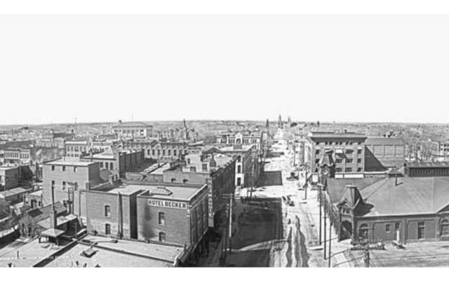 A black and white photo taken during the 1910s of what is now downtown Cheyenne. The photo is taken from the Depot clocktower and faces north towards the Wyoming State Capitol Building.