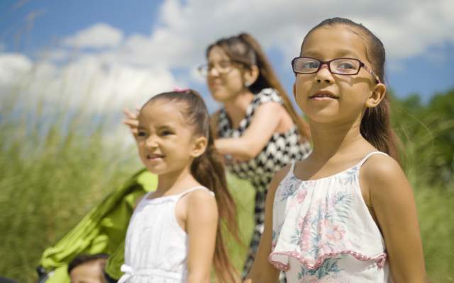 two girls and their mom walking