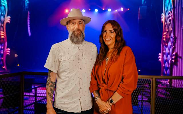 Jon and Renee standing together at The Lincoln Theater in Cheyenne, Wyoming, with stage lights in the background.