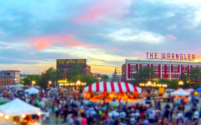 The Cheyenne Depot Plaza at sunset with tents and people enjoying a festival
