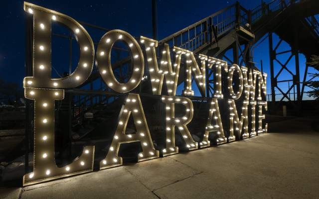 Downtown Laramie temporary sign at Garfield Street Footbridge 2022