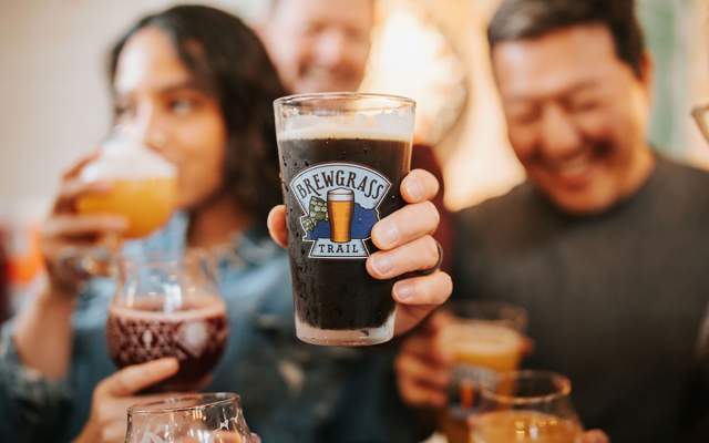 People enjoying beverages on the brewgrass trail