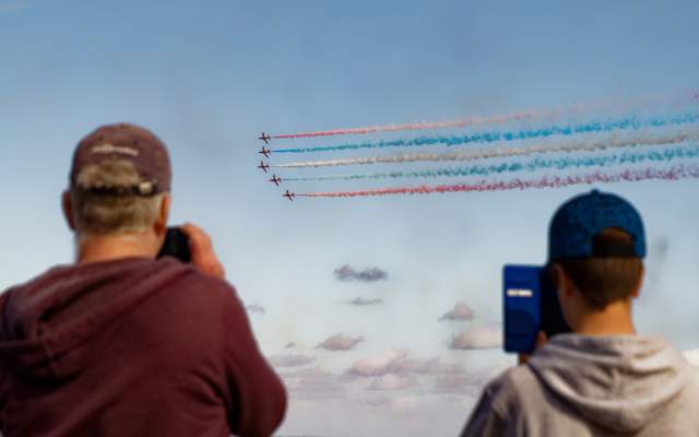 People taking photos of the red arrows at the Wales Airshow