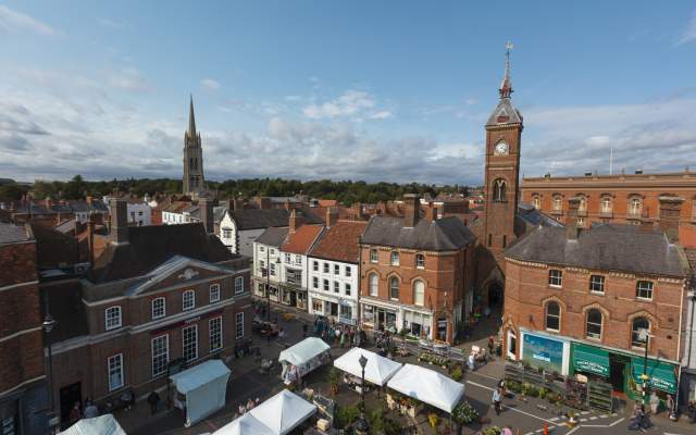 a skyline of Louth with market square below and church in background under blue skies