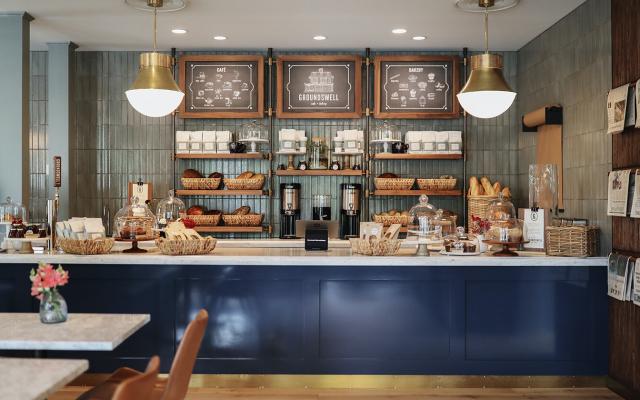 A breakfast counter with pastries and coffee.