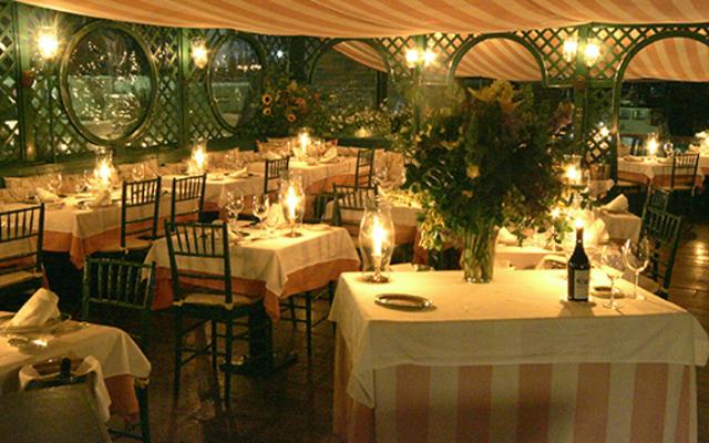 A formal dining room with tables set for dinner