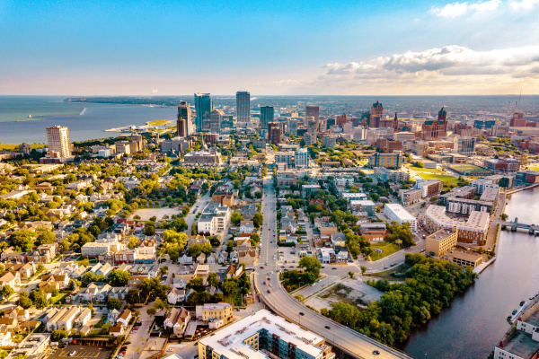 view of the Milwaukee skyline from a drone over Lake Michigan and the Milwaukee River