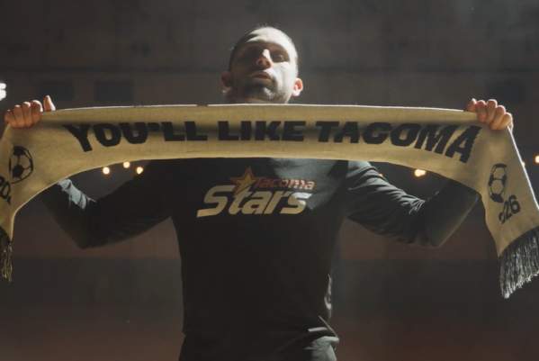 Soccer player showing off FIFA World Cup Tacoma Scarf