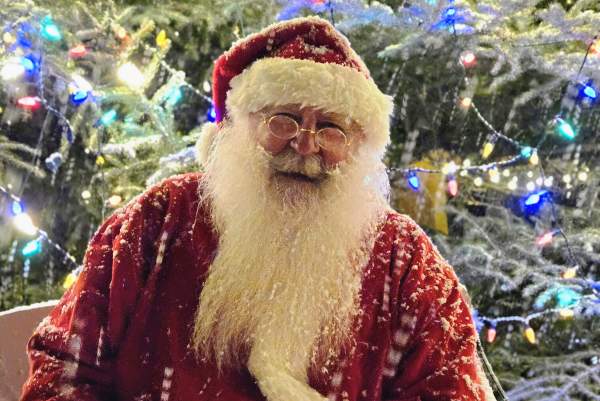 Santa in the snow at the Grand Lake Tree Lighting Ceremony