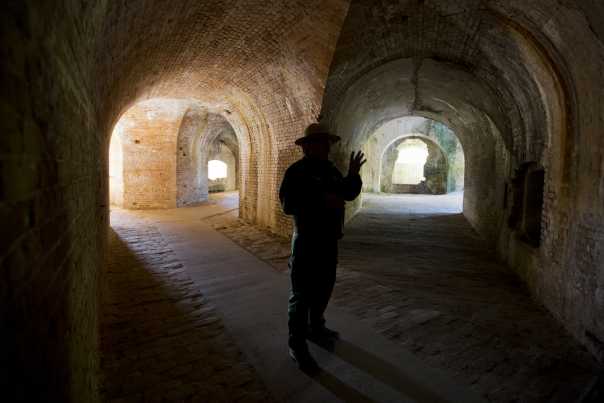 There is light at the end of two tunnels. In the darkness, a park ranger