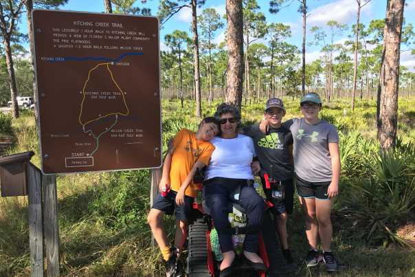 Paula Russo, uses the park’s track chair to explore trails at Jonathan Dickinson State Park with family members.