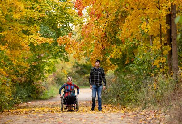 Two people on a fall hike in Madison, WI with colorful leaves