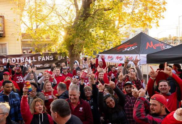 Badger sports fans cheering outside on a sportscursion