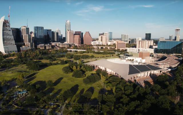 Aerial view of the Palmer Event Center and greenspace with the downtown Austin skyline in the background