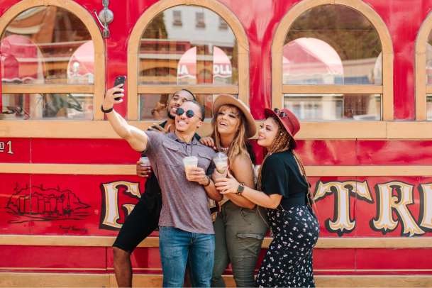 Friends taking a selfie in front of Trolley in Galena, IL