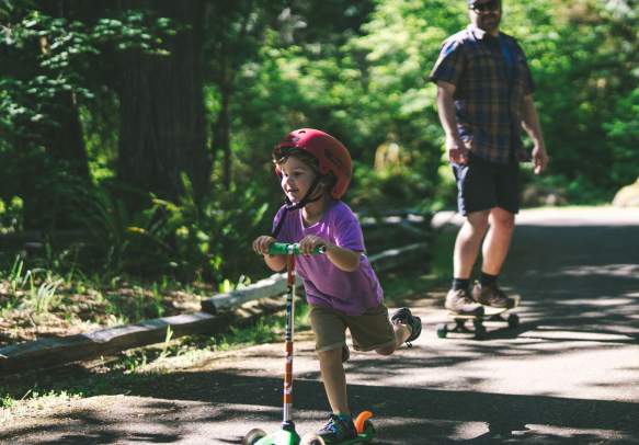 A kid riding a scooter