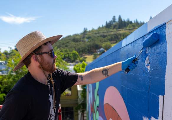 Travis working on North Forty Mural