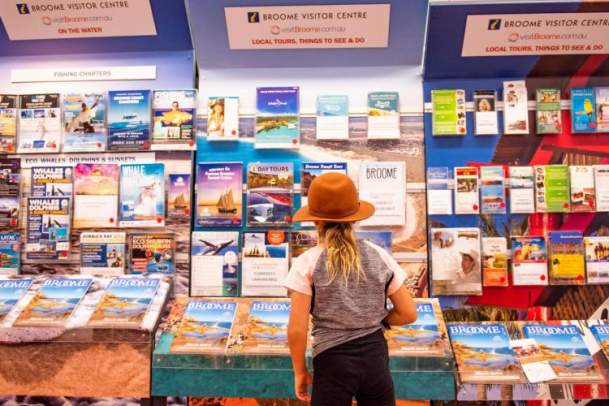 Child browsing the brochure racks at Broome Visitor Centre