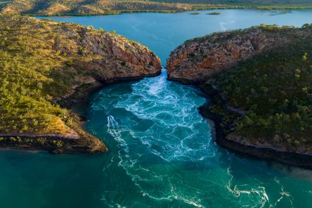 An aerial view of the tide flowing through the narrow gap at the Horizontal Falls on the Kimberley Coast