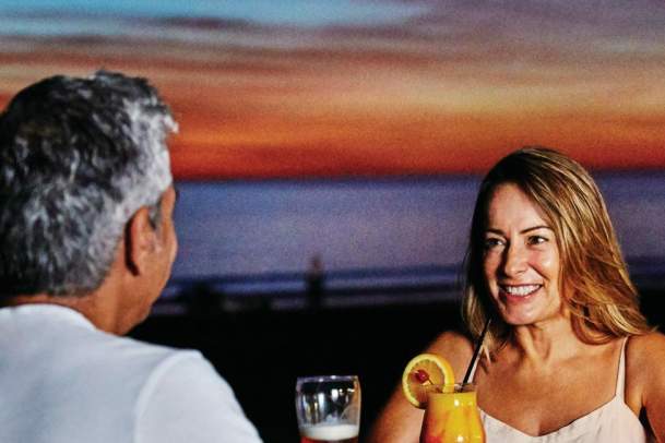 Couple at Cable Beach enjoying sunset drinks - TWA