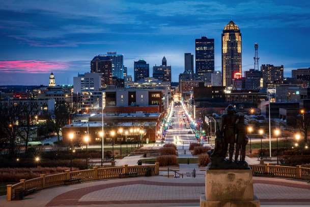 Back of sculpture at the Iowa State Capitol and Downtown Des Moines Skyline at night