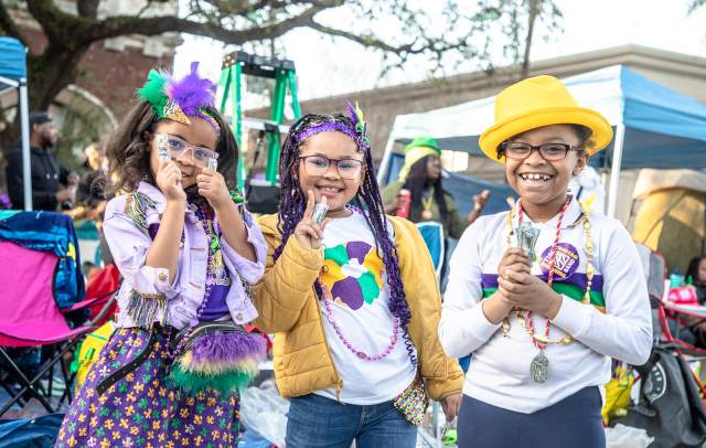 Kids Waiting for A Mardi Gras Parade to Roll