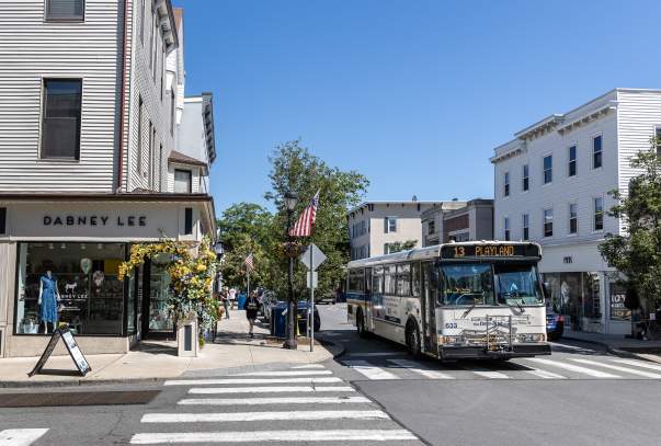A Bee-Line Bus pass through the town of Rye where the streets are lined with shops and restaurants.