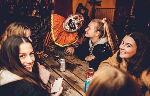 A group of friends with a clown at FEAR scream park