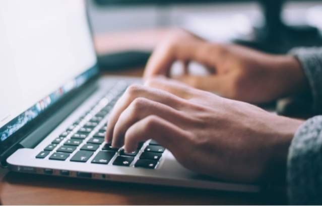 Person typing on laptop