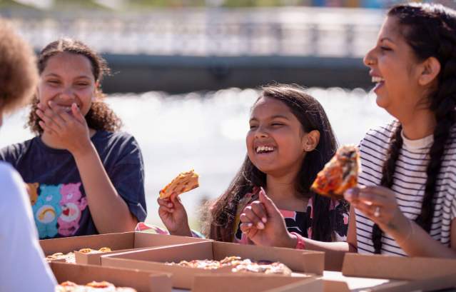 A family eating pizza at The Wave inland surfing lake near Bristol - credit The Wave